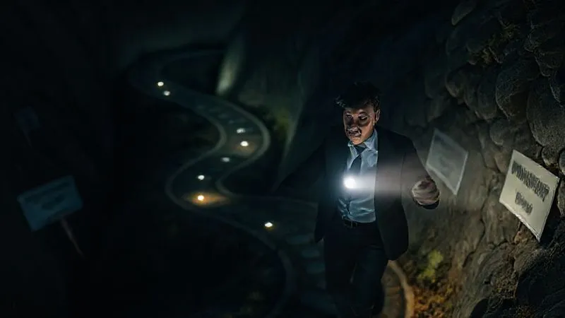 photorealistic, professional photography, 8K, cinematic lighting, sharp focus, depth of field, shot on a high-end DSLR, a business person carefully navigating a winding, dimly lit path filled with financial traps like open pits labeled 'hidden fees' and 'prepayment penalties'. They are holding a flashlight of knowledge, illuminating the dangers ahead, with a look of cautious determination.